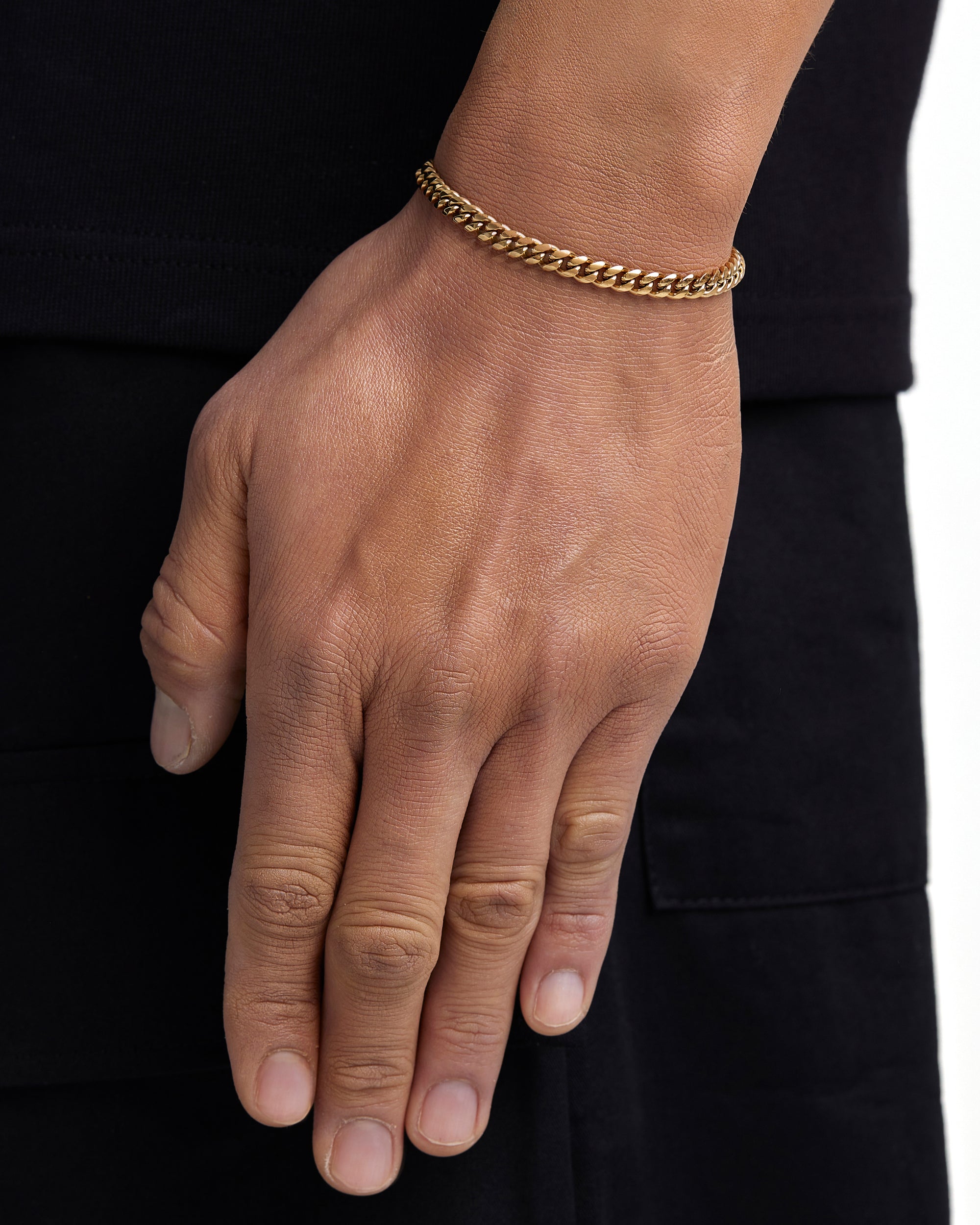 Model wearing 5mm 18k gold plain cuban bracelet by Iceman Society